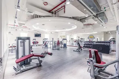 a gym with several treadmills and cardio machines at Blueground DIFC Burj K view pool fitness DXB-1535 in Dubai