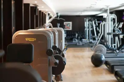 a gym with several treadmills and suitcases at Blueground Downtown B Khalifa view pool DXB-645 in Dubai