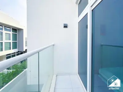 a staircase in a building with a blue door at Luxury 3-Bedroom Duplex in Damac Hills & balcony in Dubai