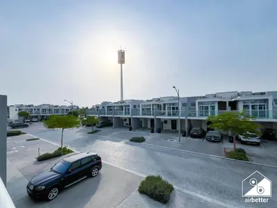a car parked in a parking lot in front of a building at Luxury 3-Bedroom Duplex in Damac Hills & balcony in Dubai