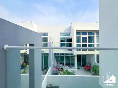 a view of a house from a balcony at Luxury 3-Bedroom Duplex in Damac Hills & balcony in Dubai