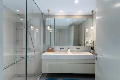 a bathroom with a sink and a shower with a mirror at Beach Isle 2, Emaar Beachfront - Mint Stay in Dubai