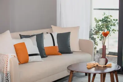 a living room with a couch with pillows and a table at Canal Vista - Home near Downtown - Awsesome views in Dubai