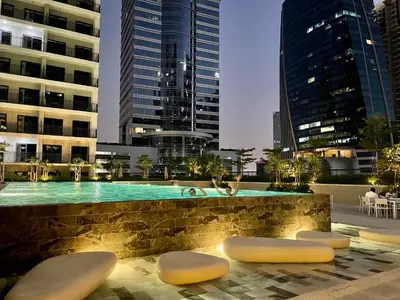 a swimming pool in the middle of a city with buildings at Canal Vista - Home near Downtown - Awsesome views in Dubai
