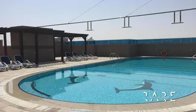 a large swimming pool on the side of a building at Rare Holiday Homes - Dubai Sports City - Elite Residence - R1303 in Dubai