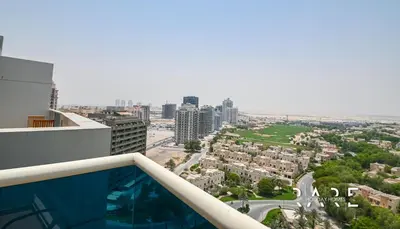 a view of a city from the balcony of a building at Rare Holiday Homes - Dubai Sports City - Elite Residence - R1303 in Dubai