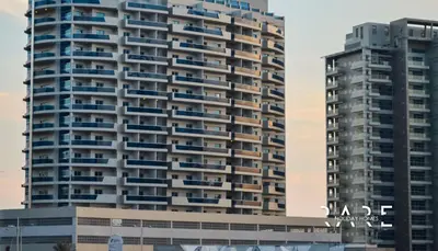 a tall building with blue balconies in front of it at Rare Holiday Homes - Dubai Sports City - Elite Residence - R1303 in Dubai