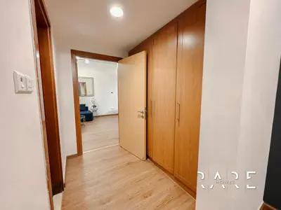 a hallway with a door leading to a room at Rare Holiday Homes - Near Circle Mall - Lavender 1 - R309 - Jumeirah Village Circle in Dubai