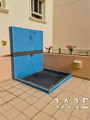 a bathroom with a shower with blue tiles at Rare Holiday Homes - Near Miracle Garden - Lavender 2 - RG012 - Jumeirah Village Circle in Dubai