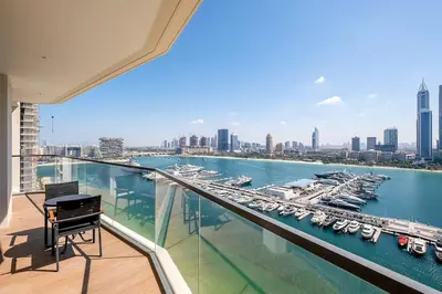 a balcony with a view of a harbor with boats at Dubai Marina Harbour View 2BR with Beach Access in Dubai