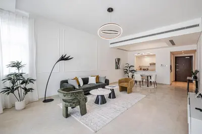 a living room with a couch and a table at Stylish Apartment Huge Terrace Near Burj Khalifa in Dubai