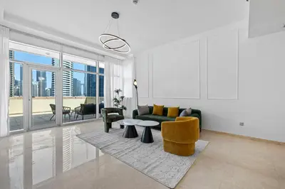 a living room with a couch and a table at Stylish Apartment Huge Terrace Near Burj Khalifa in Dubai