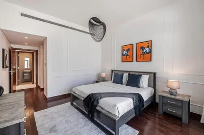a bedroom with a large bed and a table at Stylish Apartment Huge Terrace Near Burj Khalifa in Dubai