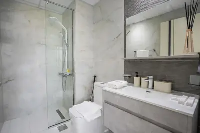 a bathroom with a shower and a toilet and a sink at Homesgetaway -Spacious 1BR Apt in Pearlz by Danube in Dubai