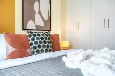 a bed with white towels on it in a room at The Smart Concierge - Time Place in Dubai