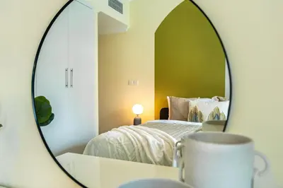 a bedroom with a bed and a mirror at The Smart Concierge - Time Place in Dubai
