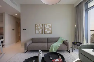 a living room with a couch and a table at Stunning Palm View 1BR Apartment in Dubai Harbour in Dubai