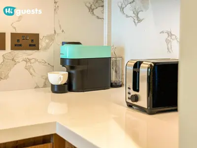 a coffee maker and a microwave on a counter at HiGuests - Sky-High Experience Luxe Living on the 24th Floor in Dubai