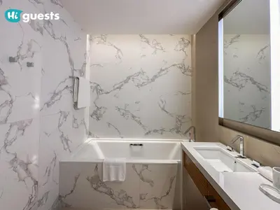 a bathroom with a white tub and a sink at HiGuests - Sky-High Experience Luxe Living on the 24th Floor in Dubai