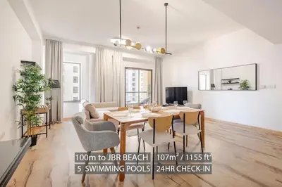 a living room with a dining room table and chairs at Stylish beachside apartment 3 beds in JBR in Dubai