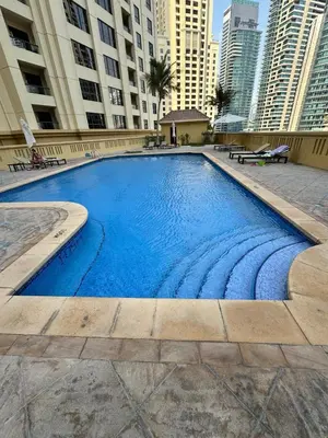 a large swimming pool in a city with tall buildings at Stylish beachside apartment 3 beds in JBR in Dubai