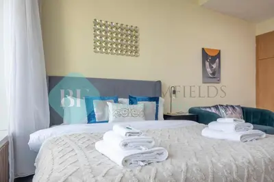 a bedroom with a bed with towels on it at Bloomfields Deluxe Stu Jlt Near Metro in Dubai