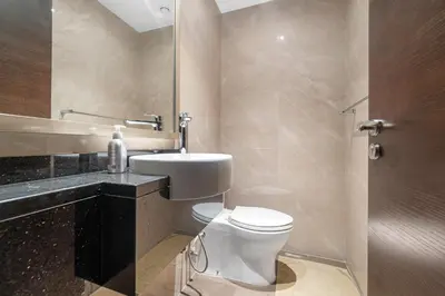 a bathroom with a toilet and a sink and a shower at Close to Downtown - New 1 bedroom with parking in Dubai