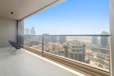 an empty chair in a room with a large window at Close to Downtown - New 1 bedroom with parking in Dubai