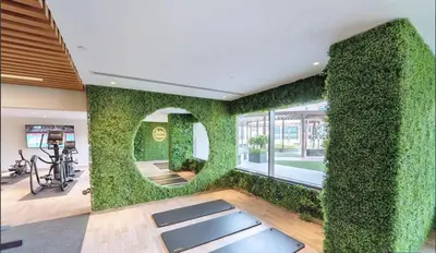 a living room with a wall covered in ivy at Close to Downtown - New 1 bedroom with parking in Dubai