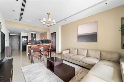a living room with a couch and a table at Big 1 bedroom close to Downtown in Dubai