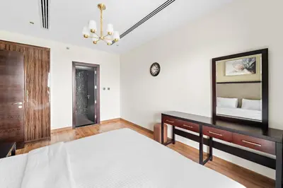 a bedroom with a bed and a mirror at Big 1 bedroom close to Downtown in Dubai