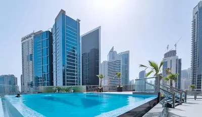 a swimming pool in a city with tall buildings at Big 1 bedroom close to Downtown in Dubai