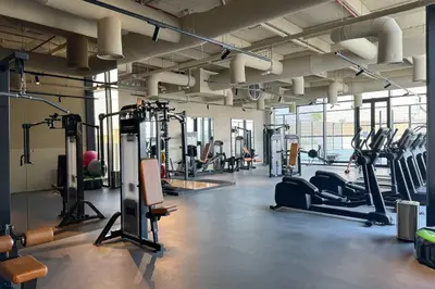 a gym with several treadmills and cardio machines at Stylish Studio in Upside Living with Top Amenities in Dubai