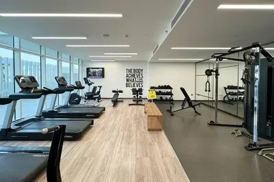 a gym with treadmills and exercise equipment in a building at Stylish Studio in Upside Living with Top Amenities in Dubai