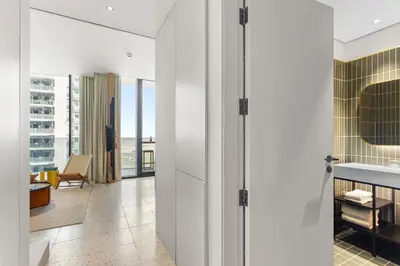a bathroom with white walls and a floor to ceiling window at Stylish Studio in Upside Living with Top Amenities in Dubai