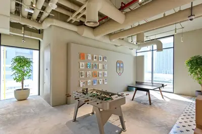a room with a ping pong table and a table at Stylish Studio in Upside Living with Top Amenities in Dubai