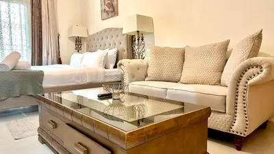 a living room with a bed and a couch at Charming Studio Retreat in Central JVC by Bhavan Vacation Homes in Dubai