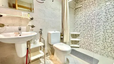 a bathroom with a toilet and a sink and a shower at Charming Studio Retreat in Central JVC by Bhavan Vacation Homes in Dubai