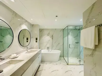 a bathroom with two sinks and a tub and a shower at Manzil - 2BR Home with Waterfront Views in Palm in Dubai