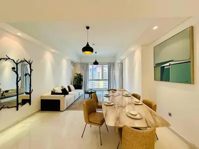 a living room with a table and a couch at Manzil - 2BR Home with Waterfront Views in Palm in Dubai