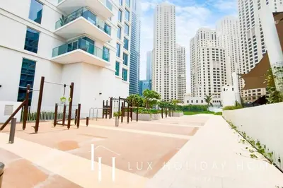 a walkway in a city with tall buildings at LUX The JBR Garden View Suite in Dubai