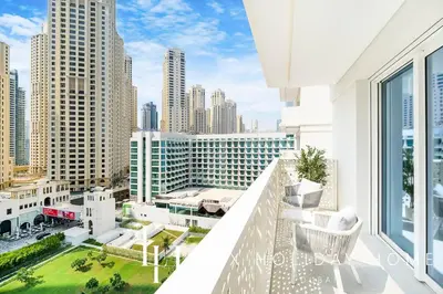an apartment balcony with a view of the city at LUX The JBR Garden View Suite in Dubai