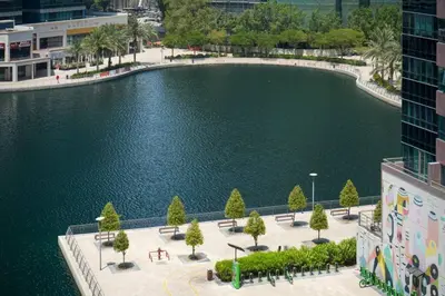 an aerial view of a pool of water in a city at Amazing lake skyline view cozy apartment in Dubai