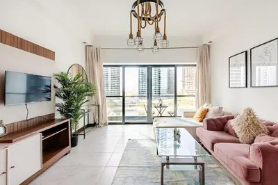 a living room with a couch and a tv at Amazing lake skyline view cozy apartment in Dubai