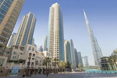 a group of tall buildings in a city with palm trees at The Residences II - One Bed with Burj Khalifa View in Dubai