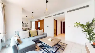 a living room with a couch and a table at The Residences II - One Bed with Burj Khalifa View in Dubai