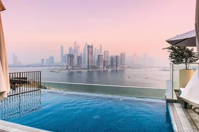 a swimming pool with a view of the city at Seven Palms in Dubai