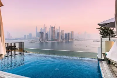 a swimming pool with a view of the city at Seven Palms in Dubai