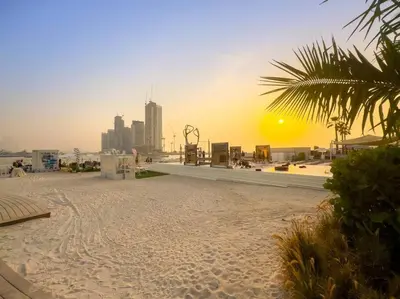 a sandy beach with a city in the background at Five Palm Luxury - 2BR with Pool View, Gym & Prime Beach Stay in Dubai