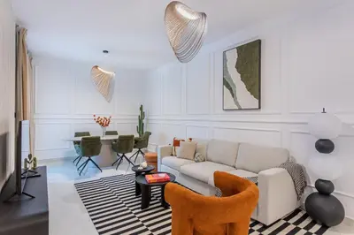 a living room with a couch and a table at Comfy 1BR Marina Living Steps from Marina Walk in Dubai